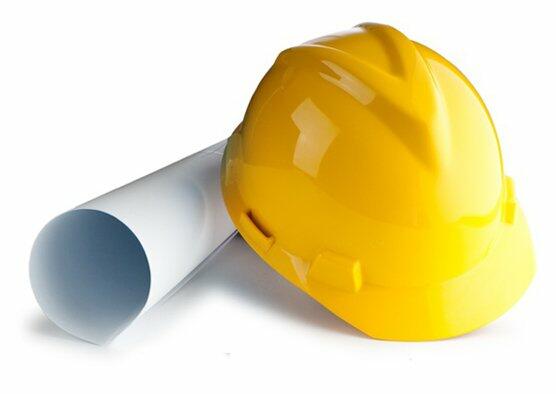 slice-8 (Demo) - JF Improvements home & commercial remodeling with a Yellow Hard Hat sitting on top of roll up paper