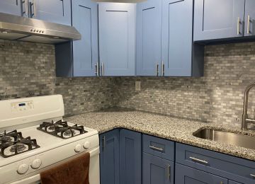 kitchen with blue painted cabinets and a matching title background