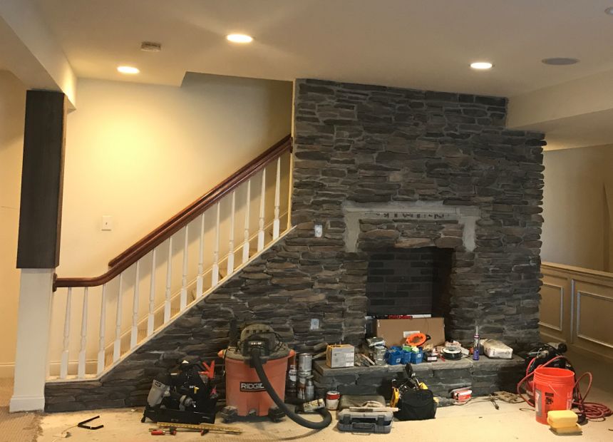 chimney restoration with faux stone wall